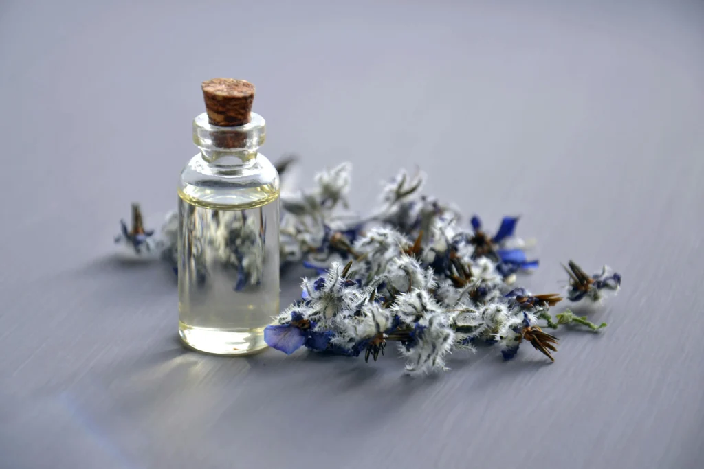 Essential oil bottles with lavender flowers in the background