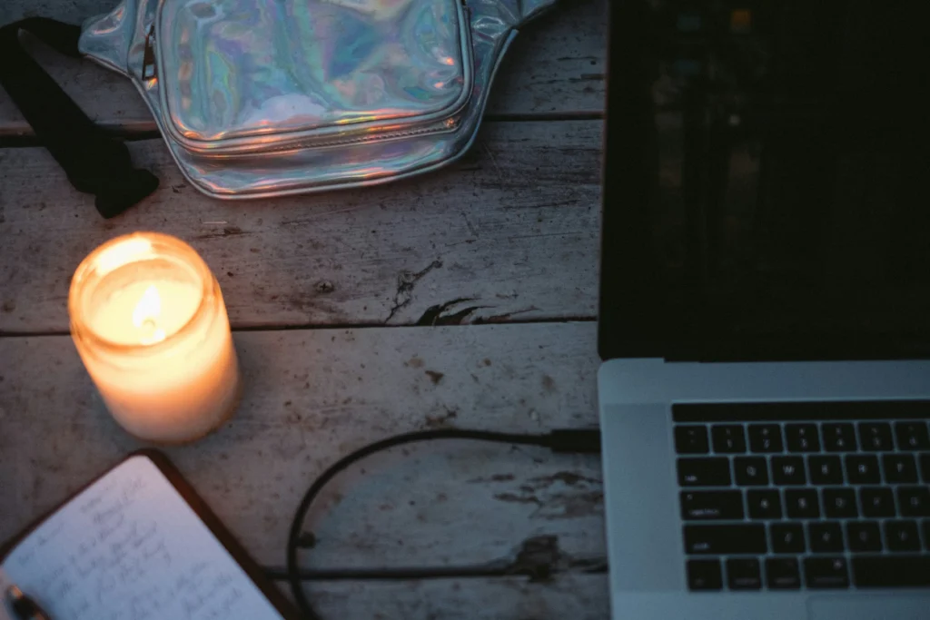 blogger writing spiritual content with candlelit desk setup