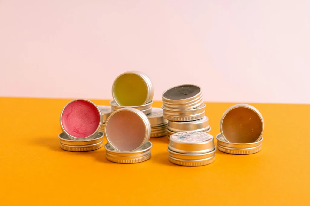 Assorted handmade lip balms in colorful tins