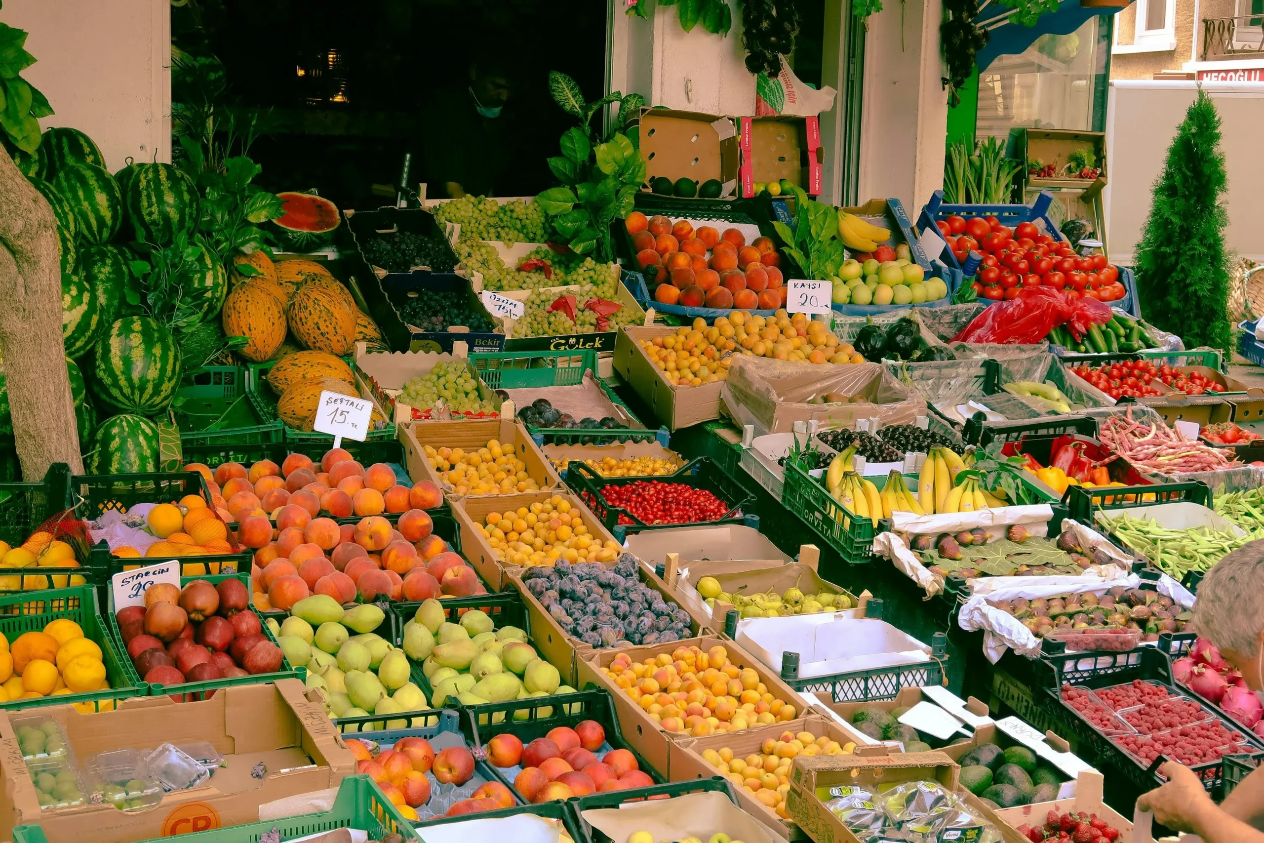 Local farmers' market stall selling fresh fruits and vegetables